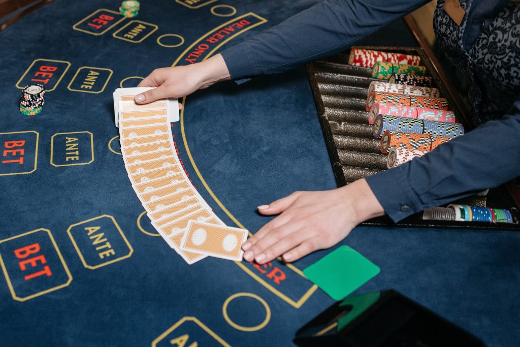 A Person Lying Down the Cards on the Gaming Table